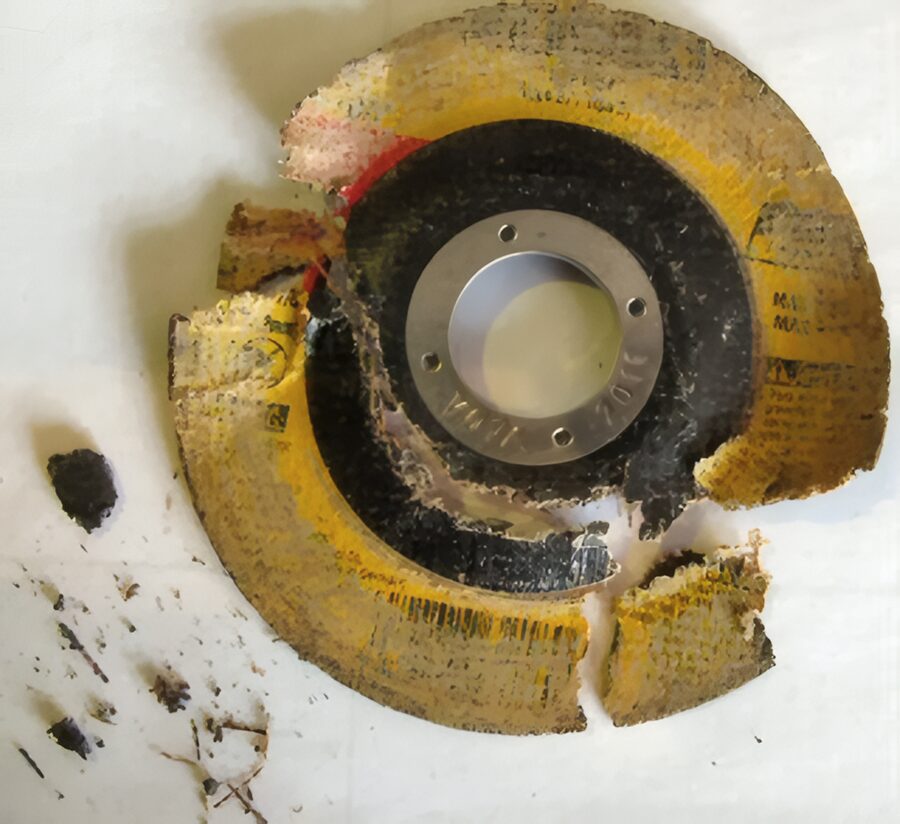 Burst abrasive wheel with its fragments laid out for examination